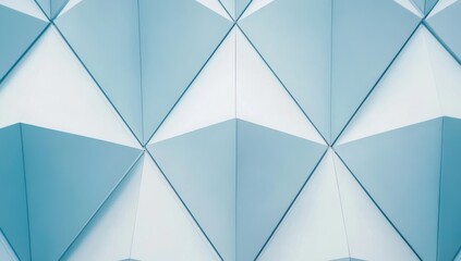 Light-blue and white, geometric pattern of interlocking triangles. Close-up view of a modern facade with a repeating, three-dimensional, polygonal design