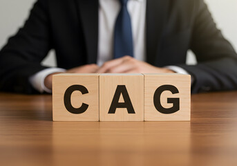 Naklejka premium Understanding cag cost per acquired customer with business man in suit and wooden blocks on table