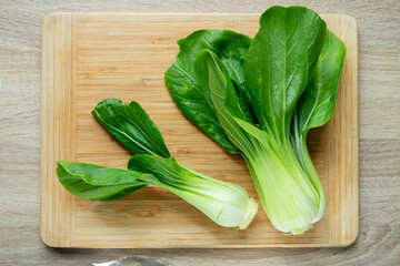 Fresh Chinese cabbage pak choi on a wooden board.