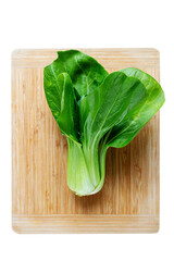 Fresh Chinese cabbage pak choi on a wooden board. Vertical top view