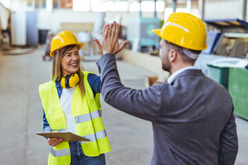 Construction Colleagues Celebrating Success With a High-Five on the Job Site