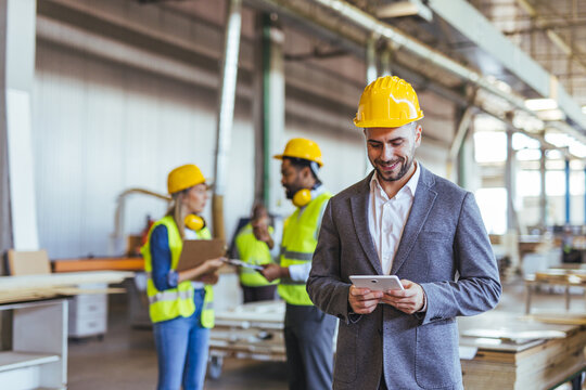 Confident Manager Working With a Team of Workers in a Warehouse Environment