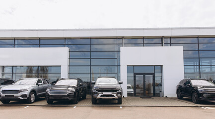 Modern car dealership exterior with parked vehicles showcasing automotive retail
