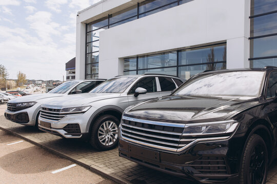 New suv cars parked in front of a modern car dealership