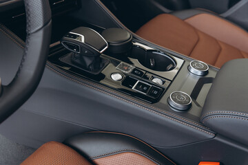 Modern Car Interior Showing Gear Stick, Cupholder, and Controls
