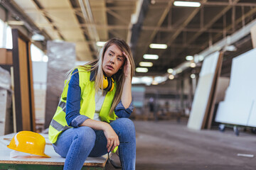 Tired Female Construction Worker Taking a Break at a Job Site