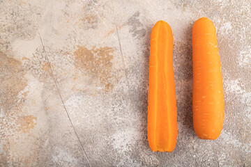 Orange Carrot on brown concrete, Top view, copy space