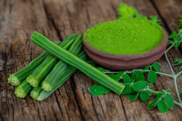Moringa oleifera powder, Drumstick leaf powder on wooden background
