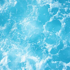 Obraz premium Aerial view of turquoise ocean water with white foam creating abstract patterns in tropical location