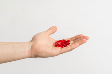 Tablets and pills on the palm of a person. Man holds a lot of pills in hands. Top View