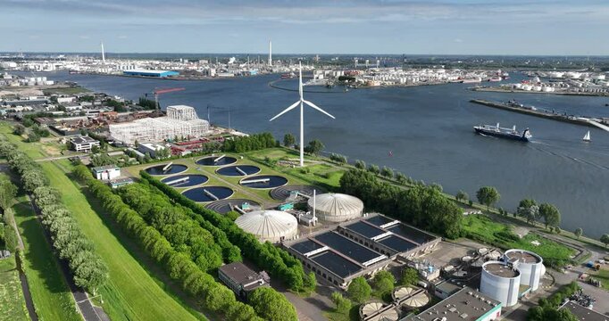 Waste water treatment plant in the port of Rotterdam, along the Meuse river. Cleanign water. Utility in industrial port area. The Netherlands. Aerial view.