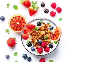 Granola with yogurt and fresh fruit. Organic gourmet muesli with ingredients, overhead flat lay shot on a white background with a place for text