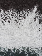 Aerial View of Waves Crashing on Rocky Shore