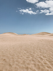 Wide View of Desert Sand Dunes Under Blue Sky