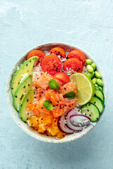 Poke bowl with salmon. Hawaiian salad with rice, fish, tomato, and avocado. Healthy diet. Shot from the top