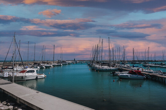 Beautiful marina at sunset with colorful skies in Italy