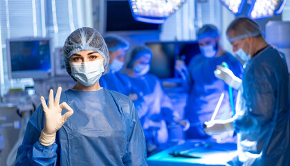 Collaborative healthcare team. A surgical team in scrubs and masks collaborates in a modern...