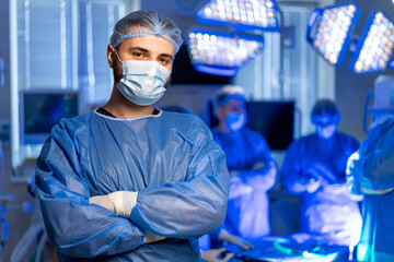 Surgeons readying for surgery. Medical team prepares for surgery in a modern operating room with...