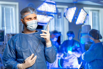 Surgery team at hospital. A surgical team is engaged in a procedure, with the lead surgeon...