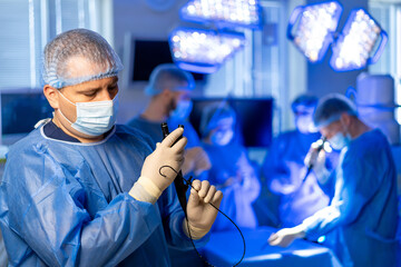 Surgeons at work in hospital. Medical professionals in scrubs and masks actively engaged in a...