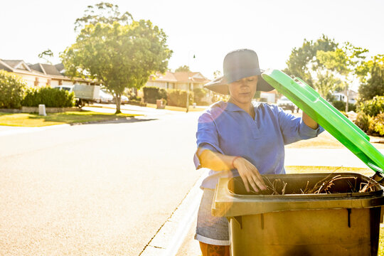Woman Tending to Outdoor Chores in Australian Neighborhood