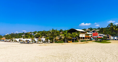 Sun beach people waves and boats in Puerto Escondido Mexico.