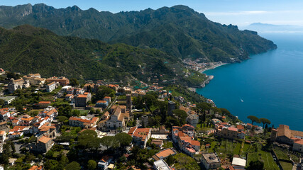 Fototapeta premium Aerial view of the cathedral of Santa Maria Assunta and San Pantaleone in the main square of Ravello. This church is located in the Amalfi Coast, Campania, Italy. In background are Maiori and Minori.