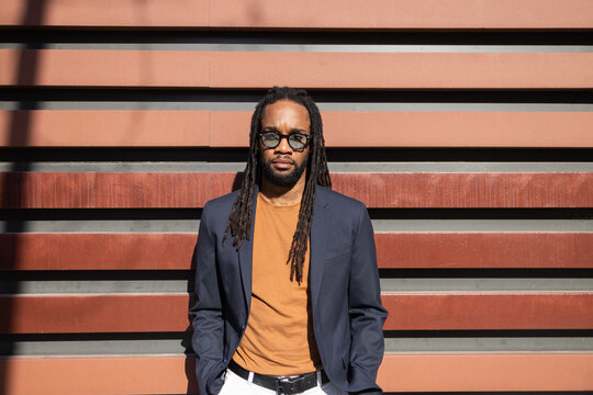 Cuban business man with dreadlocks in stylish attire outdoors