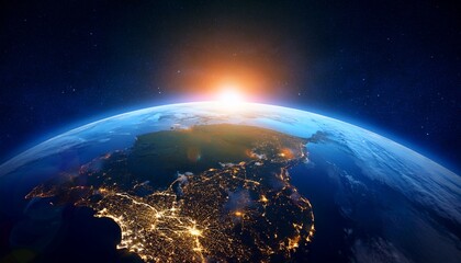 Fototapeta premium an awe inspiring image showing the curvature of earth as seen from space during sunrise with the glowing horizon and twinkling city lights against a dark backdrop