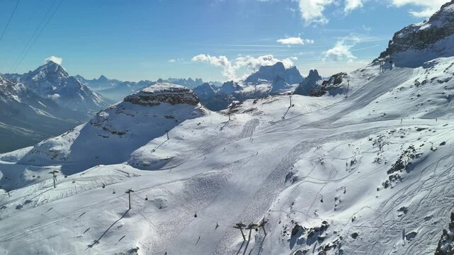 Cortina d'Ampezzo, Italy: Aerial view of famous ski resort in Dolomites (Dolomitic Alps)  and venue of Winter Olympics Milano Cortina 2026, sunny day - landscape panorama of Europe from above
