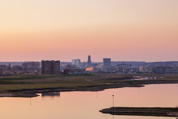 Naklejka premium Sunset view of the city center of Arnhem, The Netherlands with the Nederrijn river in front