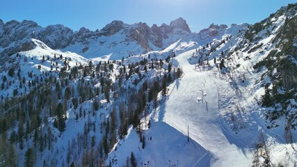 Cortina d'Ampezzo, Italy: Aerial view of famous ski resort in Dolomites (Dolomitic Alps)  and venue of Winter Olympics Milano Cortina 2026, sunny day - landscape panorama of Europe from above
