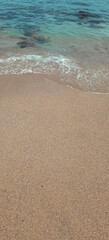 Calming beach scenery capturing the shoreline where golden sand meets turquoise water