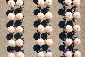Aerial photo documentation of the beach in Versilia umbrellas aligned at the beginning of summer,