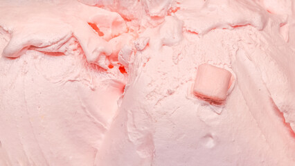 Smooth textured background of pink strawberry bubblegum ice cream with marshmallow pieces