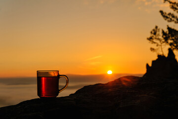 A hot cup of tea at dawn in the mountains.