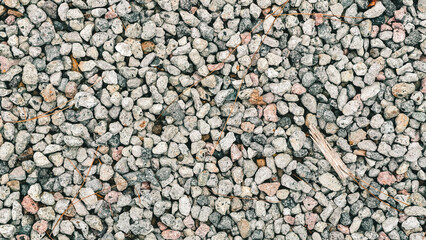 Elevated full frame perspective of weathered pebbles on a ground surface