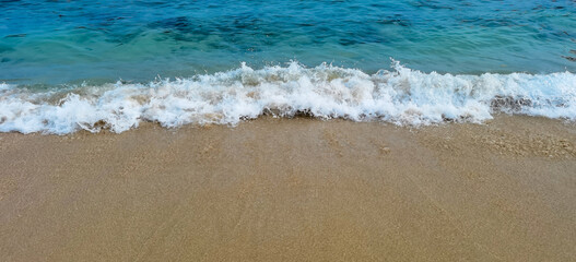 Gentle ocean waves meeting soft sand, a serene coastal scene and summer dream