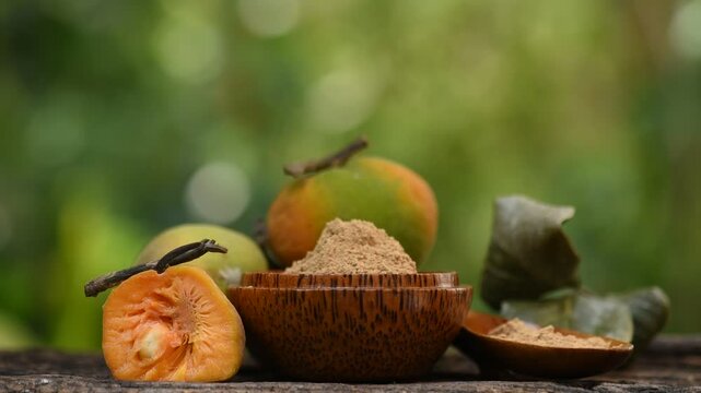 Monkey Fruit or Artocarpus lacucha Buch.-Ham. fruits and powder on natural background.