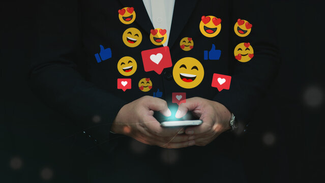 Businessman using smartphone with social media reaction icons floating. Concept of digital marketing, online engagement, influencer growth, and modern communication technology.