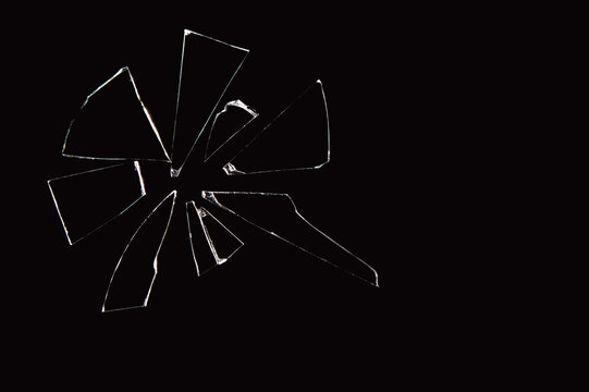 shards of broken glass pane isolated on black background