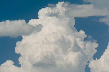 White cumulus clouds on clear blue sky background close up, beautiful aerial cloudscape view, azure skies backdrop, copy space.