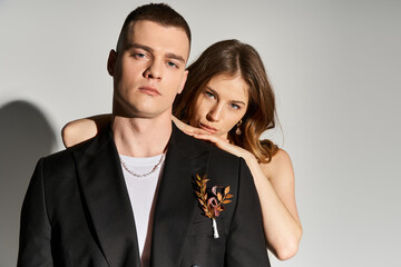 Elegant couple sharing a romantic moment in a modern setting during a wedding shoot