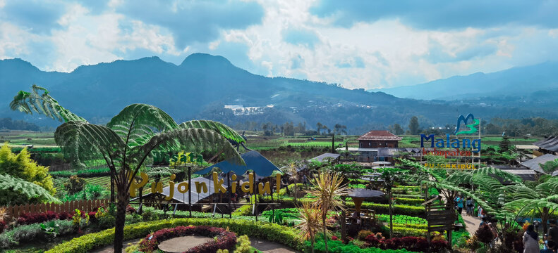 Panoramic view of enchanting park with mountain backdrop and landscaped flora. East Java, Batu - May 16, 2022 