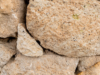 Weathered stone wall texture with cracked cement details
