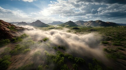 Desert mountain range blurred by swirling dust clouds under intense sunlight, dramatic natural forces