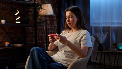 Young Woman Frustrated by Mobile Phone While Sitting in a Cozy Room