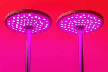 Two indoor garden lights emitting pink light for plant growth studio shot close up modern design