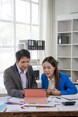 Business Colleagues Analyzing Data on Tablet