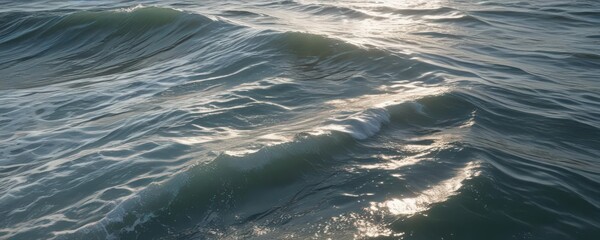 Naklejka premium Sunlit ocean surface, abstract wavy texture, whitecaps , light, sun